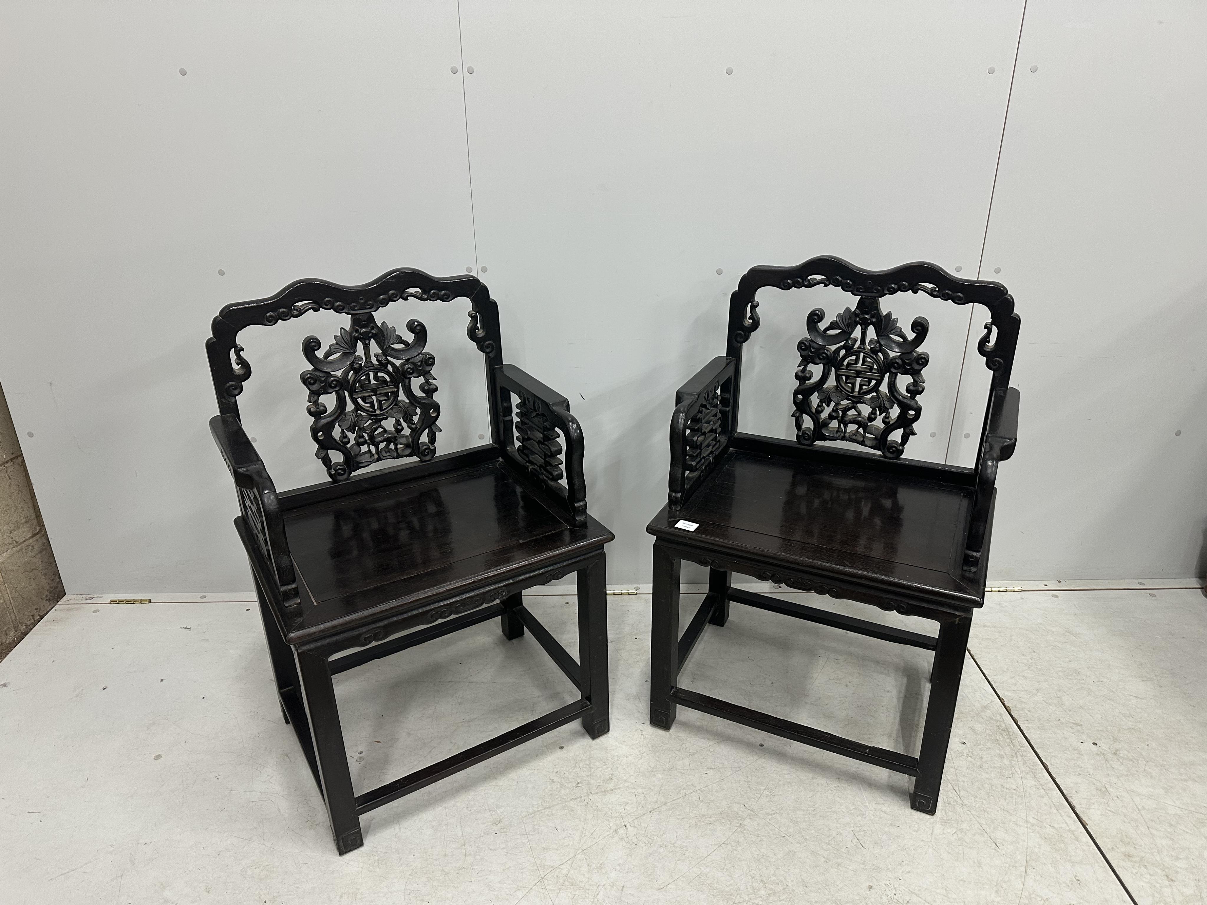 A pair of Chinese hongmu elbow chair, width 64cm, depth 46cm, height 98cm. Condition - fair